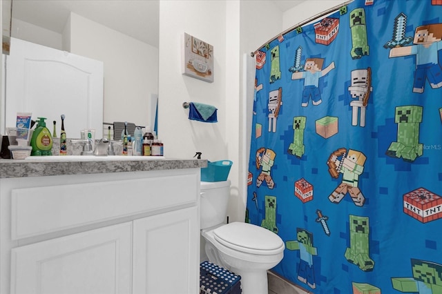 bathroom featuring a shower with shower curtain, tile patterned flooring, vanity, and toilet