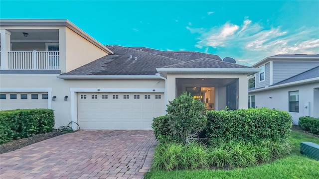 view of front of home with a balcony and a garage