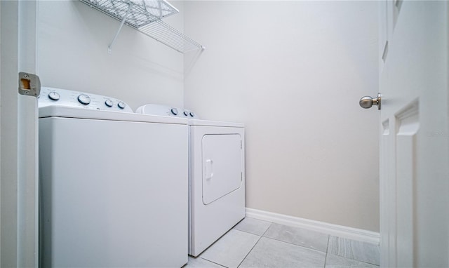 washroom with washer and clothes dryer and light tile patterned floors