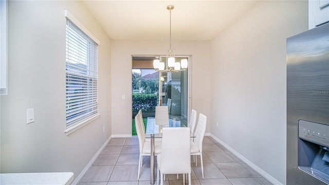 unfurnished dining area featuring an inviting chandelier and light tile patterned floors