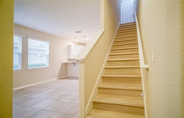 stairs featuring tile patterned floors