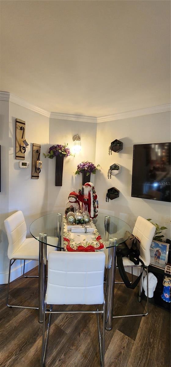 dining room featuring hardwood / wood-style flooring and ornamental molding