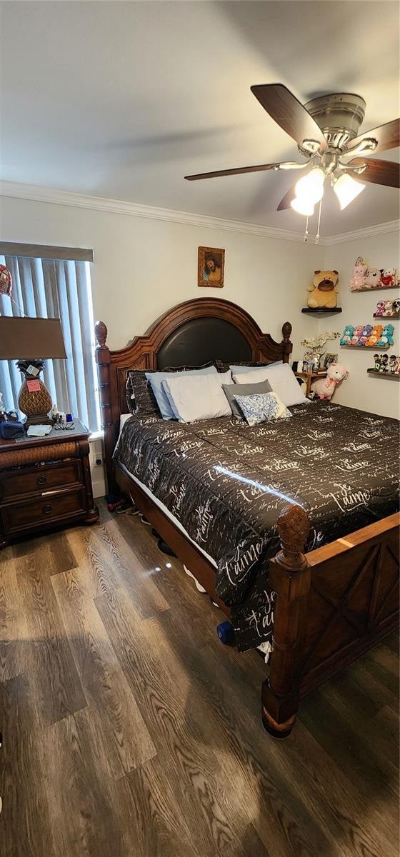 bedroom featuring ornamental molding, wood-type flooring, and ceiling fan