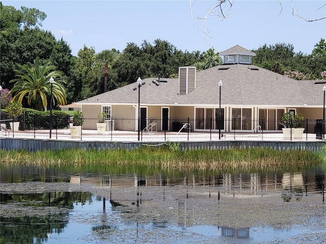 back of house with a water view