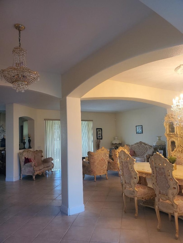 dining room featuring tile patterned floors and an inviting chandelier