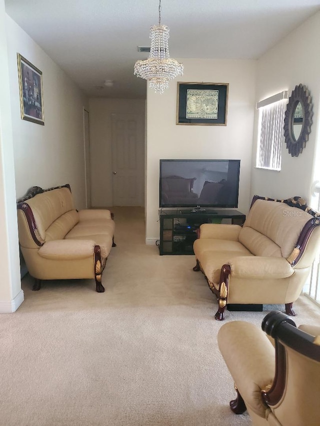 living room with a chandelier and carpet flooring