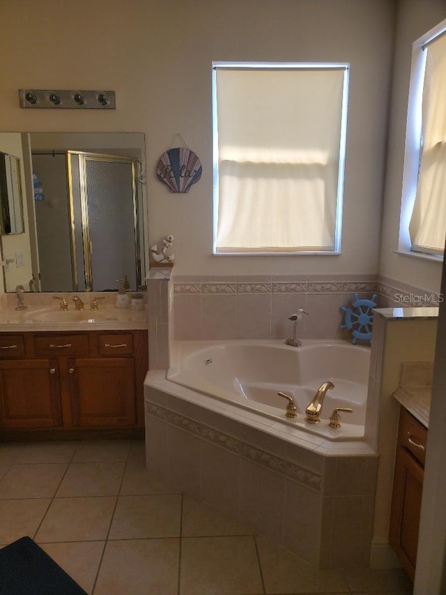 bathroom with vanity, independent shower and bath, and tile patterned flooring