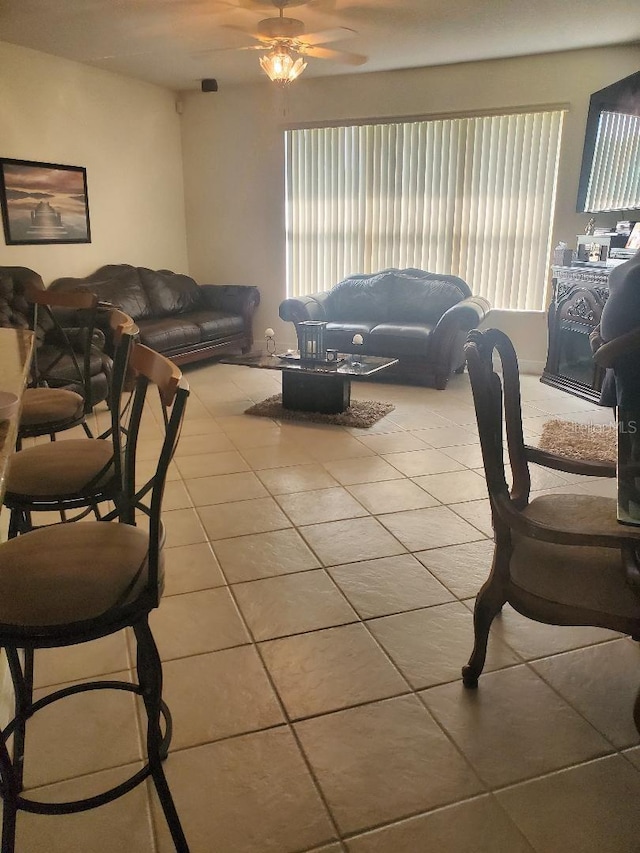 living room featuring light tile patterned flooring, a wealth of natural light, and ceiling fan