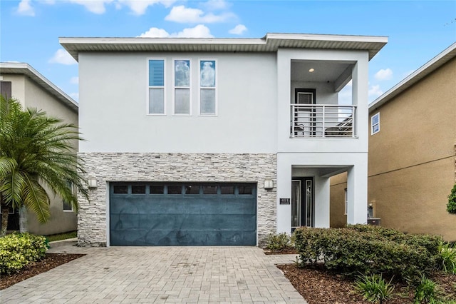 view of front of home featuring a balcony and a garage