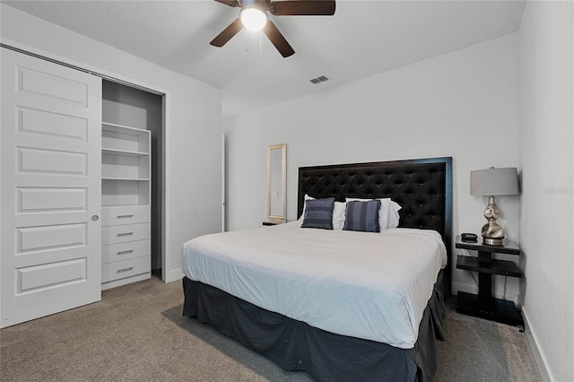 carpeted bedroom with ceiling fan and a closet