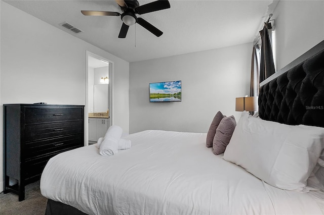 bedroom featuring ceiling fan, ensuite bathroom, and carpet flooring