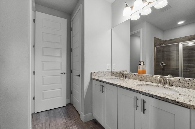 bathroom with walk in shower and vanity