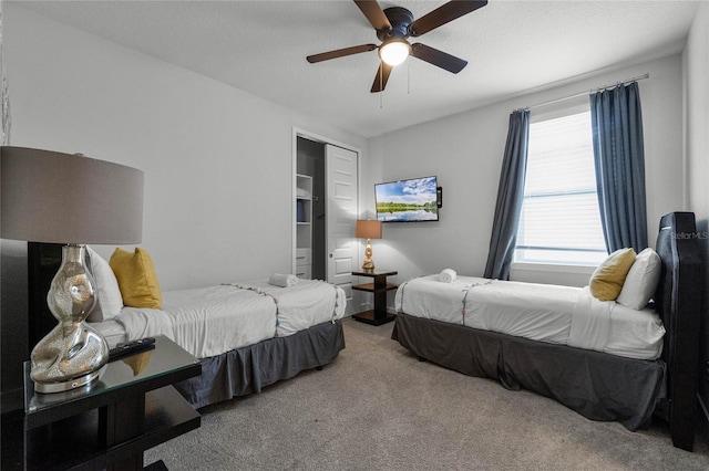 bedroom with carpet flooring, ceiling fan, and a closet