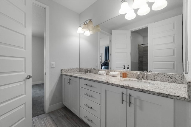 bathroom featuring walk in shower and vanity