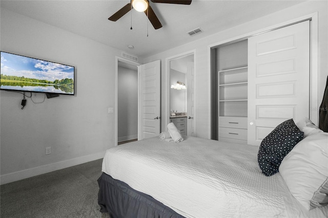 bedroom with ceiling fan, a closet, dark colored carpet, and ensuite bathroom