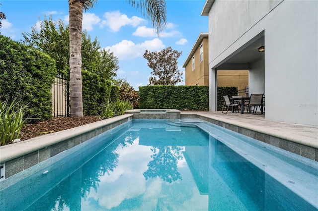 view of pool featuring an in ground hot tub and a patio area