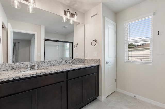 bathroom featuring vanity, tile patterned floors, and a shower with shower door