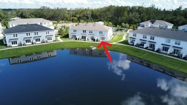 birds eye view of property with a water view