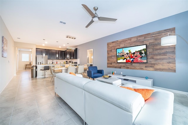 tiled living room featuring ceiling fan