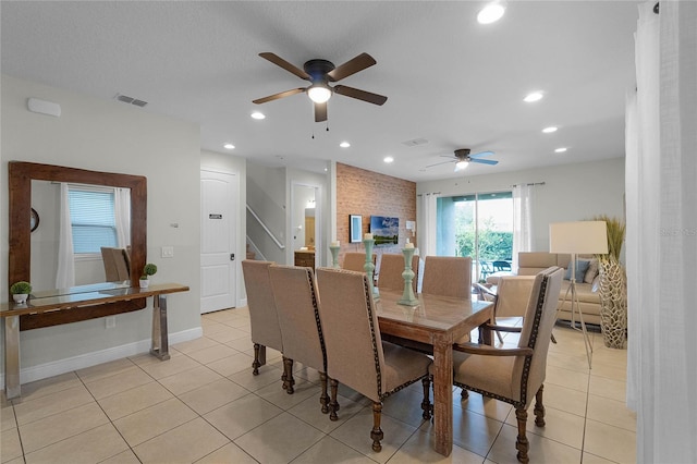 tiled dining area with ceiling fan