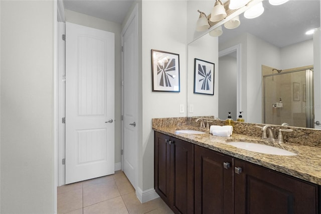 bathroom featuring vanity, tile patterned flooring, and a shower with door