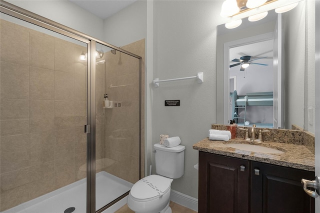 bathroom with ceiling fan, vanity, toilet, and an enclosed shower