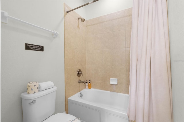 bathroom with shower / bath combination with curtain and toilet