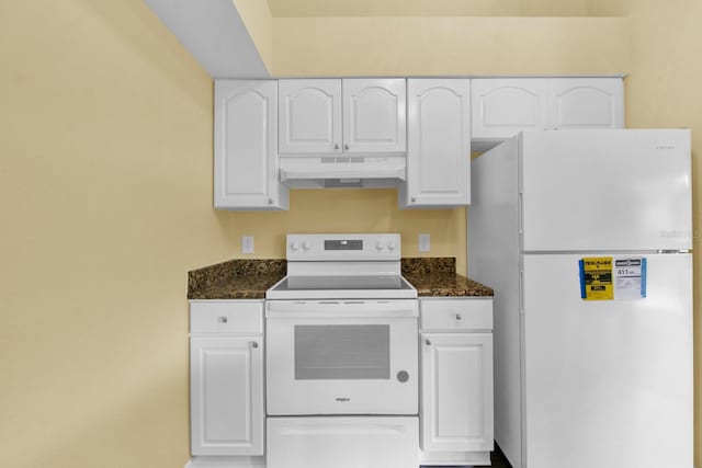 kitchen featuring dark stone counters, white appliances, and white cabinetry