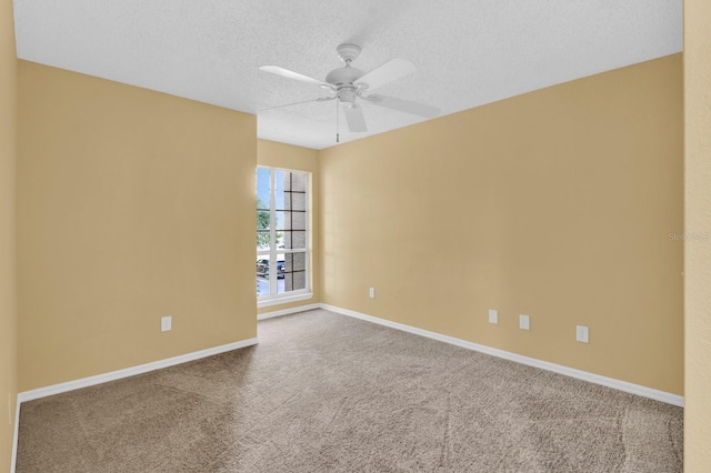 empty room featuring ceiling fan, a textured ceiling, and carpet flooring