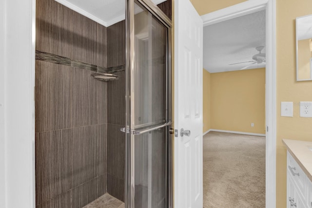 bathroom with ceiling fan, vanity, and an enclosed shower