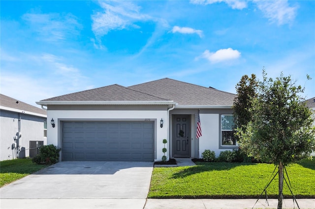 ranch-style home featuring a front lawn, cooling unit, and a garage