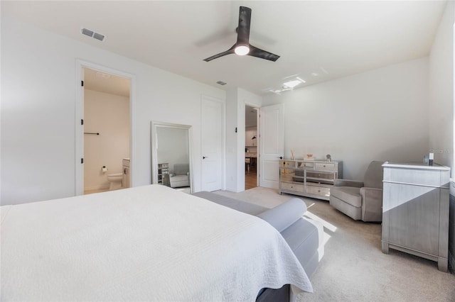 carpeted bedroom with connected bathroom and ceiling fan