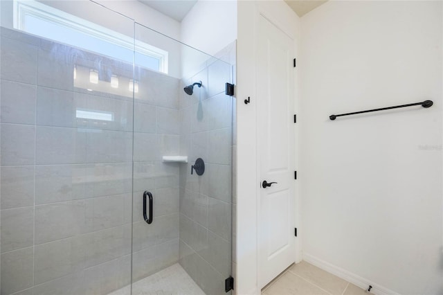 bathroom featuring tile patterned floors and a shower with shower door