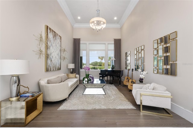 living room featuring ornamental molding, a chandelier, dark wood-type flooring, and a high ceiling