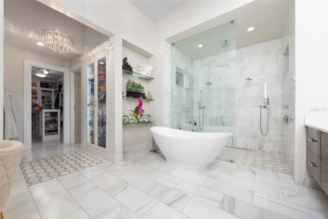 bathroom with vanity, a notable chandelier, and plus walk in shower