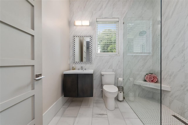 bathroom featuring vanity, toilet, a tile shower, and tile walls