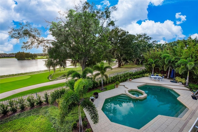 view of pool featuring a patio, an in ground hot tub, and a water view