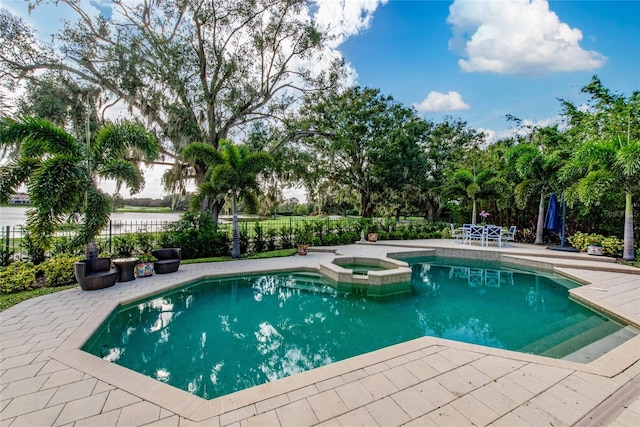 view of pool featuring an in ground hot tub and a patio area