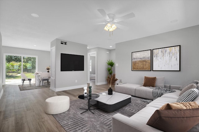 living room featuring hardwood / wood-style floors and ceiling fan