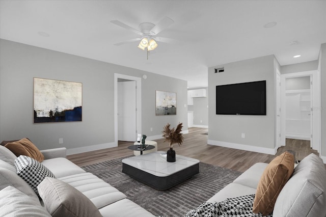 living room featuring hardwood / wood-style flooring and ceiling fan