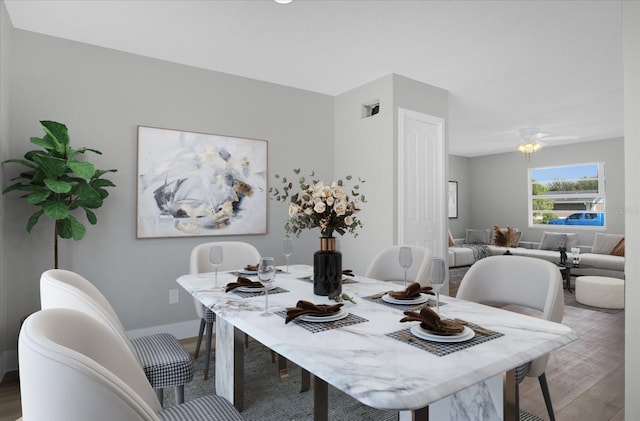 dining space featuring wood-type flooring