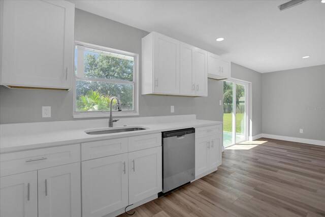 kitchen featuring white cabinetry, plenty of natural light, sink, and stainless steel dishwasher