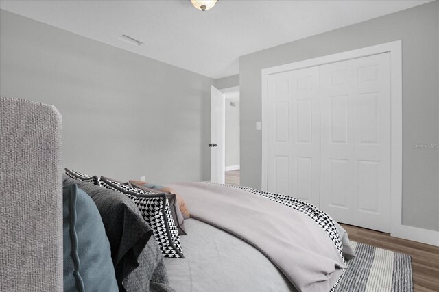 bedroom featuring hardwood / wood-style flooring and a closet