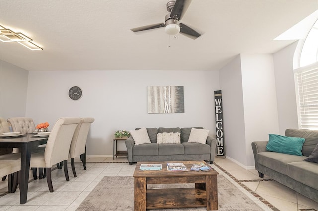 living room with ceiling fan and light tile patterned flooring