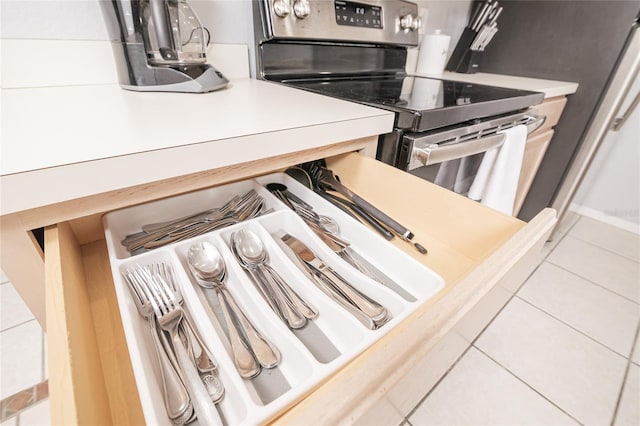 kitchen featuring tile patterned flooring and electric stove