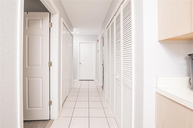 corridor with light tile patterned floors