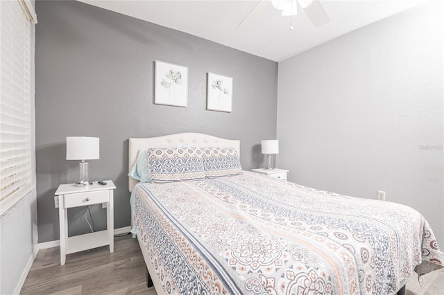 bedroom with ceiling fan and hardwood / wood-style flooring