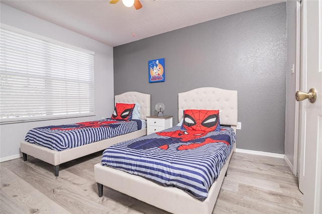 bedroom with light hardwood / wood-style floors and ceiling fan