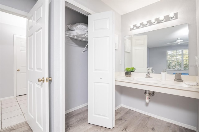 bathroom featuring wood-type flooring, ceiling fan, and vanity