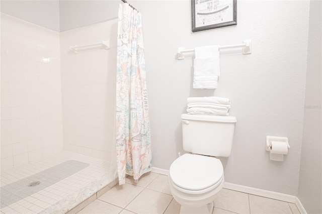 bathroom featuring tile patterned flooring, toilet, and a shower with curtain